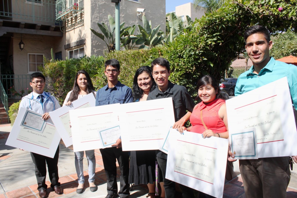 scholarship students holding checks